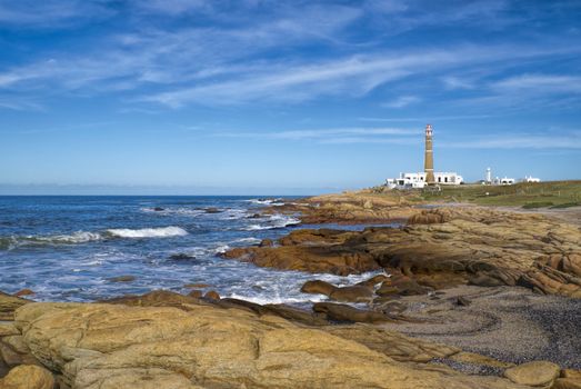 Picturesque view of a lighthouse standing on the coast in Cabo Polonio