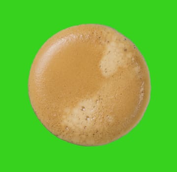 Top view of coffee cream with green background.