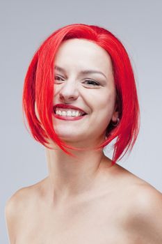 Portrait of a Young Woman in Red Wig - Isolated on Gray