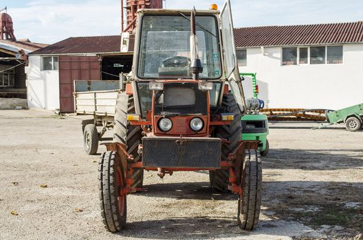 Old farm tractor may be still in use, but very rusty