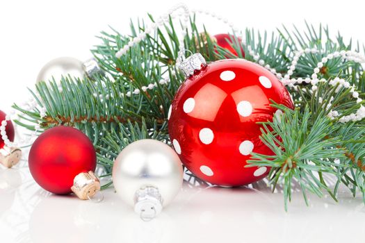 Christmas balls and fir branches with decorations isolated over white