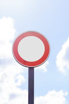 round road sign with white area and sky in the background