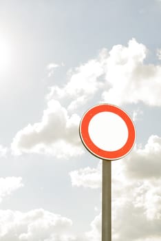round road sign with white area and sky in the background