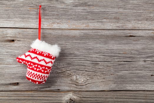 Red mitten on wooden background