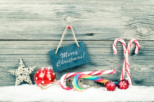 Christmas decoration with xmas canes, over wooden background