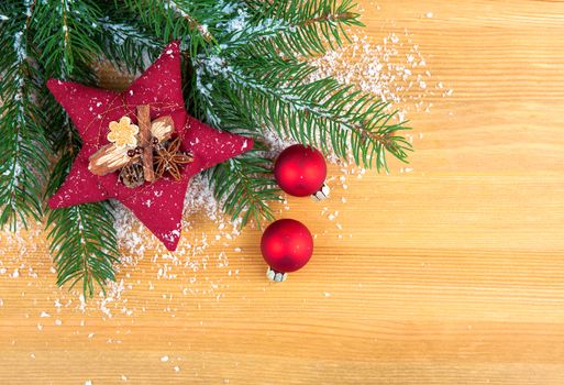 Bright christmas composition with red stars and red Christmas ball, on wooden background