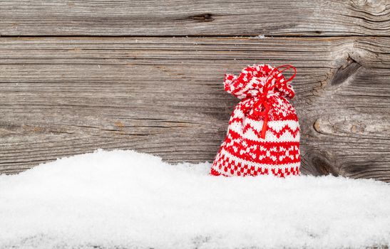 Gift Bags with winter snow on wooden boards, with copyspace