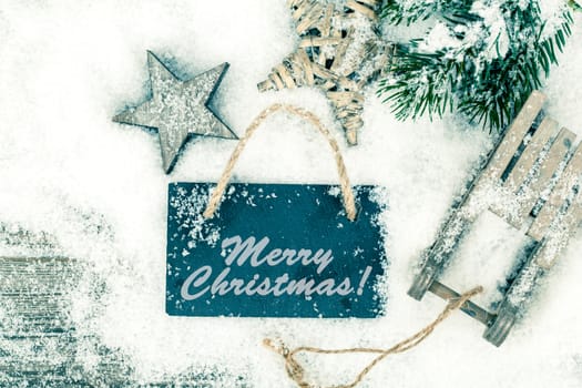 Christmas decoration over snow, wooden background