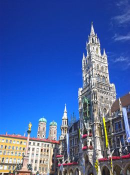 Square of medieval city (Marienplatz) with the monument and city hall in Munich.