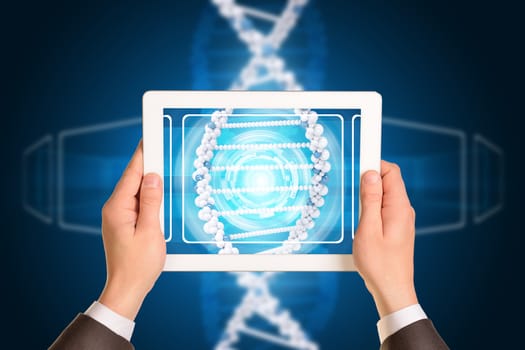 Man hands using tablet pc. Image of DNA helix on tablet screen