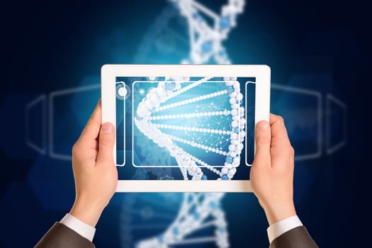 Man hands using tablet pc. Image of DNA helix on tablet screen