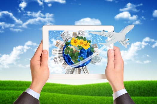 Man hands using tablet pc. Image of Earth and buildings on tablet screen. Element of this image furnished by NASA