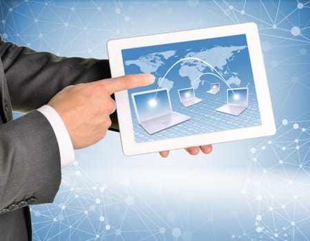 Man hands using tablet pc. Image of world map and laptops on tablet screen