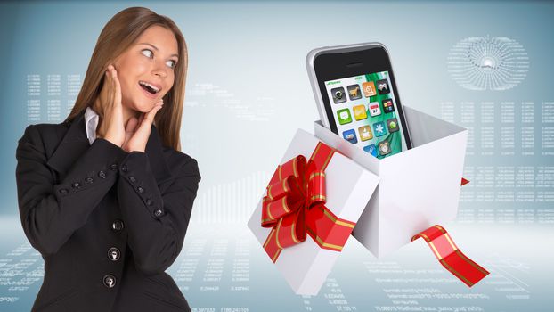 Businesswoman with joy holding hands near face. Open gift boxe with smart phone as backdrop
