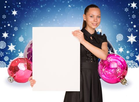 Businesswoman holding empty paper. Christmas tree balls as backdrop