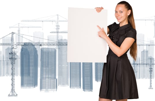 Businesswoman holding empty paper. Construction site with tower cranes as backdrop