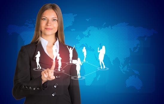 Beautiful businesswoman in suit presses finger on virtual button. World map and business silhouettes in background