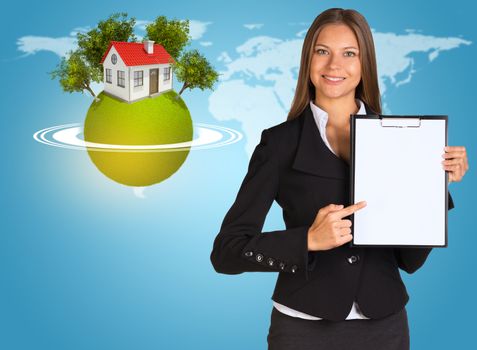 Beautiful businesswoman in suit holding paper holder. Earth with house and trees in background