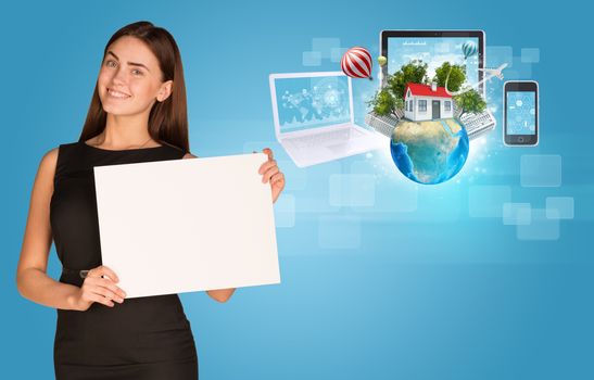 Beautiful businesswoman in dress holding paper holder. Electronics, Earth with buildings and trees in background. Elements of this image furnished by NASA