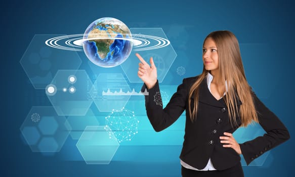 Beautiful businesswoman finger presses Earth. Hexagons and graphs in background. Elements of this image furnished by NASA