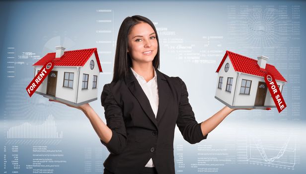 Businesswoman holding housees in hands. Business concept