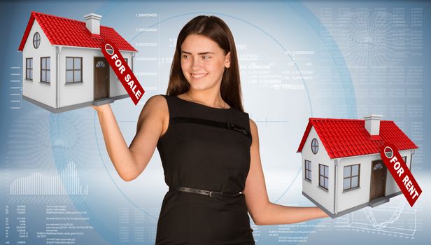 Businesswoman holding housees in hands. Business concept