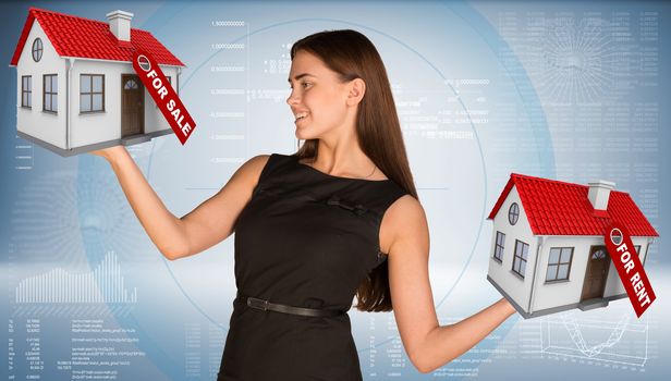 Businesswoman holding housees in hands. Business concept