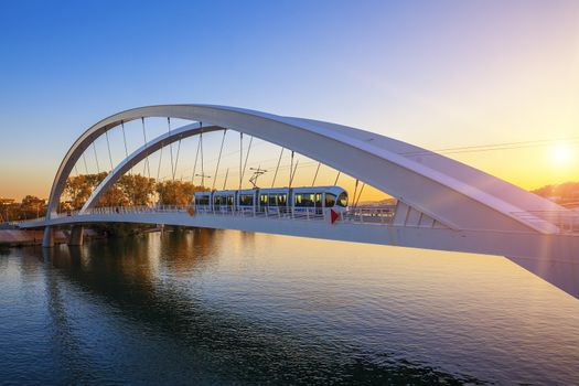 Tramway on the bridge at sunset, Lyon, France.