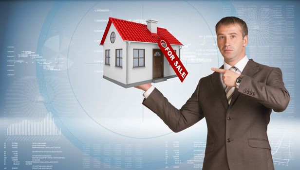 Businessman in suit holding house in hand. Business concept