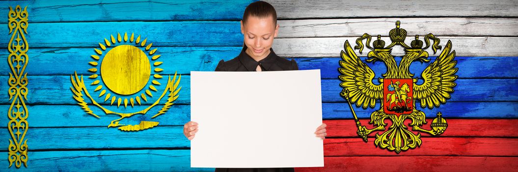 Businesswoman holding paper sheet. Kazakhstan and Russia flags as backdrop