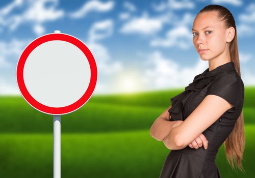 Businesswoman standing with crossed arms. Empty road sign and blured nature landscape as backdrop