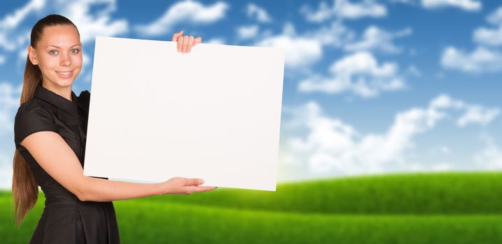 Businesswoman holding empty paper. Blured nature landscape as backdrop