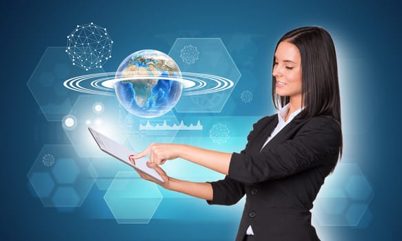 Beautiful businesswomen in suit using digital tablet. Earth with hexagons, graphs and wire-frame spheres. Element of this image furnished by NASA