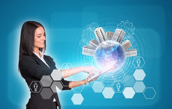 Beautiful businesswomen in suit using digital tablet. Earth with buildings. Hexagons and figures as backdrop. Element of this image furnished by NASA