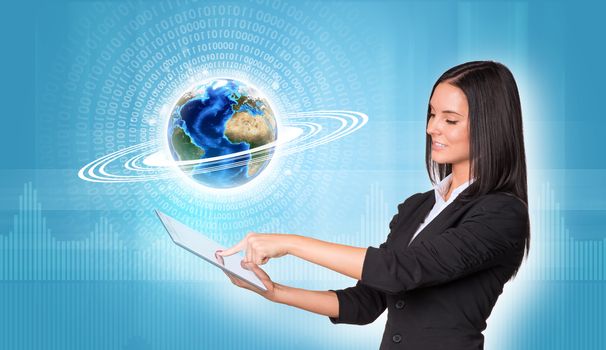 Beautiful businesswomen in suit using digital tablet. Earth with figures and graphs. Element of this image furnished by NASA