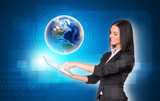 Beautiful businesswomen in suit using digital tablet. Earth with figures and transparent rectangles. Element of this image furnished by NASA