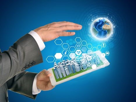 Man hands using tablet pc. Business city on touch screen. Earth and hexagons with icons near tablet. Element of this image furnished by NASA