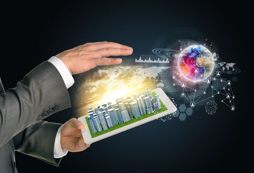 Man hands using tablet pc. Business city on touch screen. Earth with network near computer. Elements of tgis image furnished by NASA