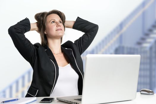 Image of a business woman sitting at her desk dreaming