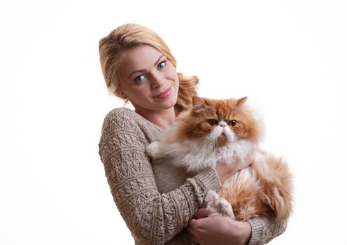 The young nice girl holds a red Persian cat on hands