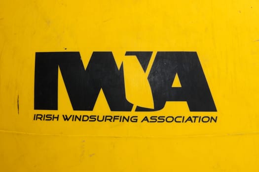 Irish windsurfing association logo on a yellow buoy