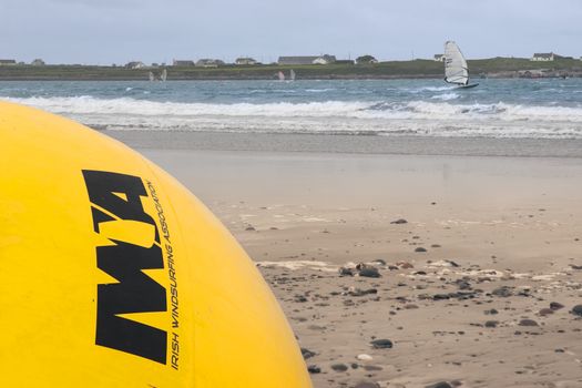 giant Irish windsurfing association yellow buoy on a beach in the wild atlantic way