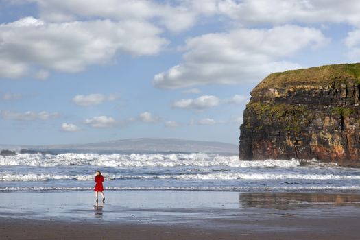 woman in high heels at cliffs of Ballybunion on the wild atlantic way in county Kerry Ireland