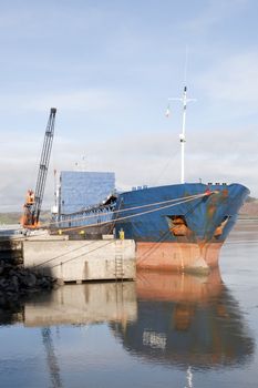 large ship being loaded with steel by crane at Youghal pier county Cork, Ireland