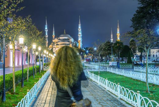 ISTANBUL - SEPTEMBER 17, 2014: Tourist enjoy night view of Blue Mosque. Istanbul is visited by more than 11 million people every year.