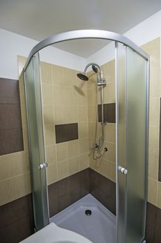 Close up image with a shower cabin in bathroom.