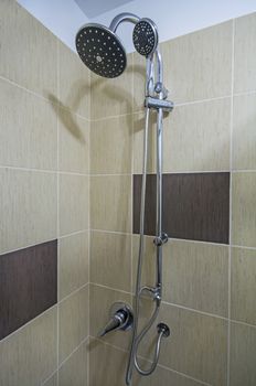 Detail of a corner shower cabin with wall mount shower.