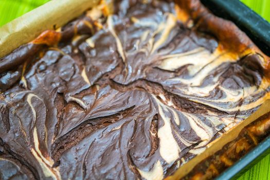 Fresh baked marble cheese cake with chocolate on cooking pan