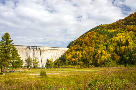 Bicaz hydroelectric dam in Romania with october forest.