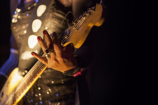 Picture of a woman playing electric guitar